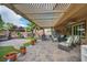 Covered patio featuring outdoor seating, a grill, and views of the beautifully landscaped yard at 2621 Icy Moon St, Henderson, NV 89044