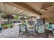 Covered patio with ceiling fan, comfortable seating, and a view of the landscaped backyard at 2621 Icy Moon St, Henderson, NV 89044