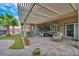 Covered patio with elegant furniture overlooking a manicured lawn, perfect for outdoor relaxation at 2621 Icy Moon St, Henderson, NV 89044