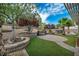 Beautiful backyard with artificial grass, stone features, mature trees, and privacy landscaping at 2621 Icy Moon St, Henderson, NV 89044