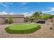 Beautiful backyard featuring a putting green, hot tub, and desert landscaping at 2621 Icy Moon St, Henderson, NV 89044