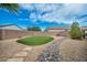 Backyard putting green surrounded by desert landscaping, rock features, and privacy wall at 2621 Icy Moon St, Henderson, NV 89044