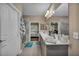 Bright bathroom featuring a double vanity, modern fixtures and a shower with a sliding glass door at 2621 Icy Moon St, Henderson, NV 89044