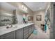 Bright bathroom featuring a double vanity, modern fixtures and a shower with a sliding glass door at 2621 Icy Moon St, Henderson, NV 89044