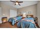This is a well lit bedroom with two beds, ceiling fan, and two side tables at 2621 Icy Moon St, Henderson, NV 89044