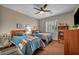 Cozy bedroom with two twin beds, ceiling fan, neutral paint, and natural light at 2621 Icy Moon St, Henderson, NV 89044
