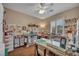 This is a craft room with organized shelves, sewing machine, work surfaces, and a bright window at 2621 Icy Moon St, Henderson, NV 89044