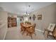 This dining room features wood floors, a chandelier, wood furniture and a bright window at 2621 Icy Moon St, Henderson, NV 89044