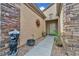 Charming entryway with stone accents, a decorative sunburst, and a welcoming bear statue at 2621 Icy Moon St, Henderson, NV 89044