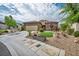 Inviting single-story home featuring stone accents, a two-car garage, and desert landscaping at 2621 Icy Moon St, Henderson, NV 89044