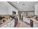 Bright kitchen with stainless steel appliances, white cabinets, and neutral countertops at 2621 Icy Moon St, Henderson, NV 89044