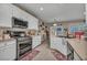 Kitchen with white cabinets, light countertops, and stainless steel appliances at 2621 Icy Moon St, Henderson, NV 89044