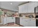 Kitchen with stainless steel appliances, white cabinets and light countertops at 2621 Icy Moon St, Henderson, NV 89044