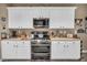 Kitchen with white cabinets, light countertops, and stainless steel appliances at 2621 Icy Moon St, Henderson, NV 89044