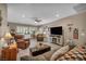 Comfortable living room features plush seating, a cozy fireplace, and bright natural light at 2621 Icy Moon St, Henderson, NV 89044