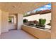View of outdoor patio space with stucco pillars and lush plants at 3827 Desert Marina Dr # 211, Laughlin, NV 89029