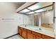Bathroom with dual sinks, wood cabinets, and a large mirror at 3827 Desert Marina Dr # 211, Laughlin, NV 89029