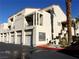 Exterior shot of condominium building featuring attached garages, stairs, balconies and desert landscaping at 3827 Desert Marina Dr # 211, Laughlin, NV 89029