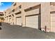 Exterior of row of garages with doors in neutral colors at 3827 Desert Marina Dr # 211, Laughlin, NV 89029