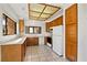 Well-lit kitchen with light wood cabinets, white appliances, and tile flooring at 3827 Desert Marina Dr # 211, Laughlin, NV 89029