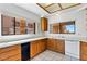 Bright kitchen featuring oak cabinets, a white dishwasher, and tiled floors at 3827 Desert Marina Dr # 211, Laughlin, NV 89029