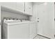 Laundry room featuring tile floors, cabinets, and a white washer and dryer at 3827 Desert Marina Dr # 211, Laughlin, NV 89029