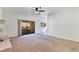 Carpeted living room featuring a ceiling fan and sliding door leading to the balcony at 3827 Desert Marina Dr # 211, Laughlin, NV 89029