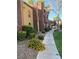 Townhome exteriors, showcasing landscaped sidewalks, and colorful flowers for curb appeal at 4050 Pacific Harbors Dr # 149, Las Vegas, NV 89121