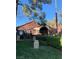 Charming home featuring a well-manicured lawn and inviting architecture with a decorative stone archway at 4050 Pacific Harbors Dr # 149, Las Vegas, NV 89121