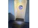 Inviting hallway with wood floors, a decorative round window, and modern lighting fixture at 4050 Pacific Harbors Dr # 149, Las Vegas, NV 89121