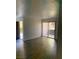 Spacious living room with new floors and sliding glass door leading to outdoor space at 4050 Pacific Harbors Dr # 149, Las Vegas, NV 89121