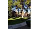 Community pool surrounded by mature trees and grassy common area at 4050 Pacific Harbors Dr # 149, Las Vegas, NV 89121