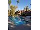 Large community pool with crystal-clear water, seating, and lush landscaping for a resort-like experience at 4050 Pacific Harbors Dr # 149, Las Vegas, NV 89121
