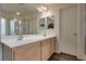 Bright bathroom featuring double sinks, modern fixtures, and a glass-enclosed shower at 4609 Hearts Desire Ave, Las Vegas, NV 89115