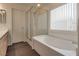 Bright bathroom showcasing a shower, large soaking tub, and window with blinds at 4609 Hearts Desire Ave, Las Vegas, NV 89115