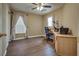 This bedroom has a ceiling fan, window with blinds, and hardwood floor at 4609 Hearts Desire Ave, Las Vegas, NV 89115