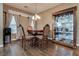 Traditional dining room with table, chairs, chandelier and glass display cabinet at 4609 Hearts Desire Ave, Las Vegas, NV 89115