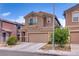 Inviting two-story home with a two-car garage and easy to maintain desert landscaping at 4609 Hearts Desire Ave, Las Vegas, NV 89115