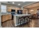 Open kitchen with breakfast bar seating and views into the dining room at 4609 Hearts Desire Ave, Las Vegas, NV 89115