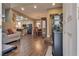 Open-concept living area with laminate floors and seamless flow to the dining area and kitchen at 4609 Hearts Desire Ave, Las Vegas, NV 89115