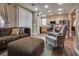 Relaxing living room with wood floors, comfortable seating, and access to kitchen at 4609 Hearts Desire Ave, Las Vegas, NV 89115