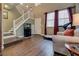 Bright living room with staircase, fish tank and accent chair at 4609 Hearts Desire Ave, Las Vegas, NV 89115