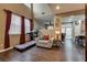 Cozy living room with treadmill, chair and lots of natural light at 4609 Hearts Desire Ave, Las Vegas, NV 89115