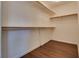 Walk-in closet with simple shelving and wood floor at 4609 Hearts Desire Ave, Las Vegas, NV 89115