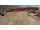 Desert backyard featuring gravel and native plants, enclosed by a rustic fence at 4831 W Bell Vista Ave, Pahrump, NV 89060