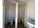 Bathroom with 2 toilet stalls, a utility sink, and light paint at 4831 W Bell Vista Ave, Pahrump, NV 89060