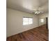 Bedroom with wood-look flooring, neutral paint, and sliding mirror closet doors at 4831 W Bell Vista Ave, Pahrump, NV 89060