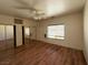 Spacious bedroom featuring hardwood floors, a ceiling fan, and a large window at 4831 W Bell Vista Ave, Pahrump, NV 89060