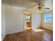 Bedroom with a window and a ceiling fan featuring a view into bathroom at 4831 W Bell Vista Ave, Pahrump, NV 89060