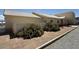 Tan single-story house featuring desert landscaping and a white tiled roof at 4831 W Bell Vista Ave, Pahrump, NV 89060